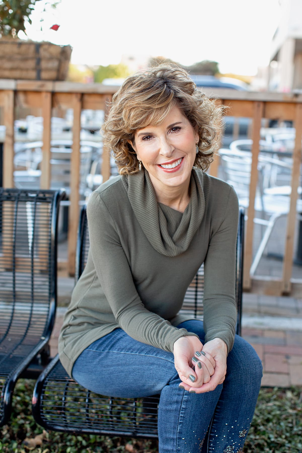 woman over fifty seated looking into camera