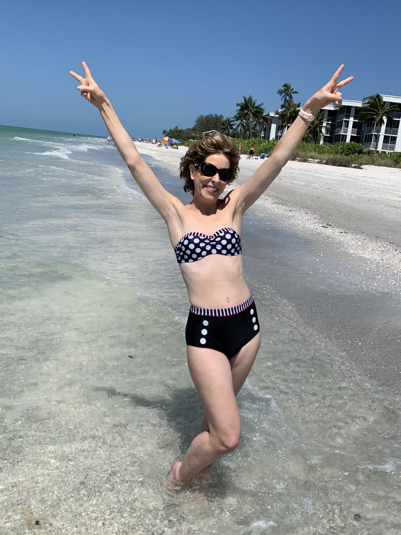 woman in two piece bathing suit on a beach