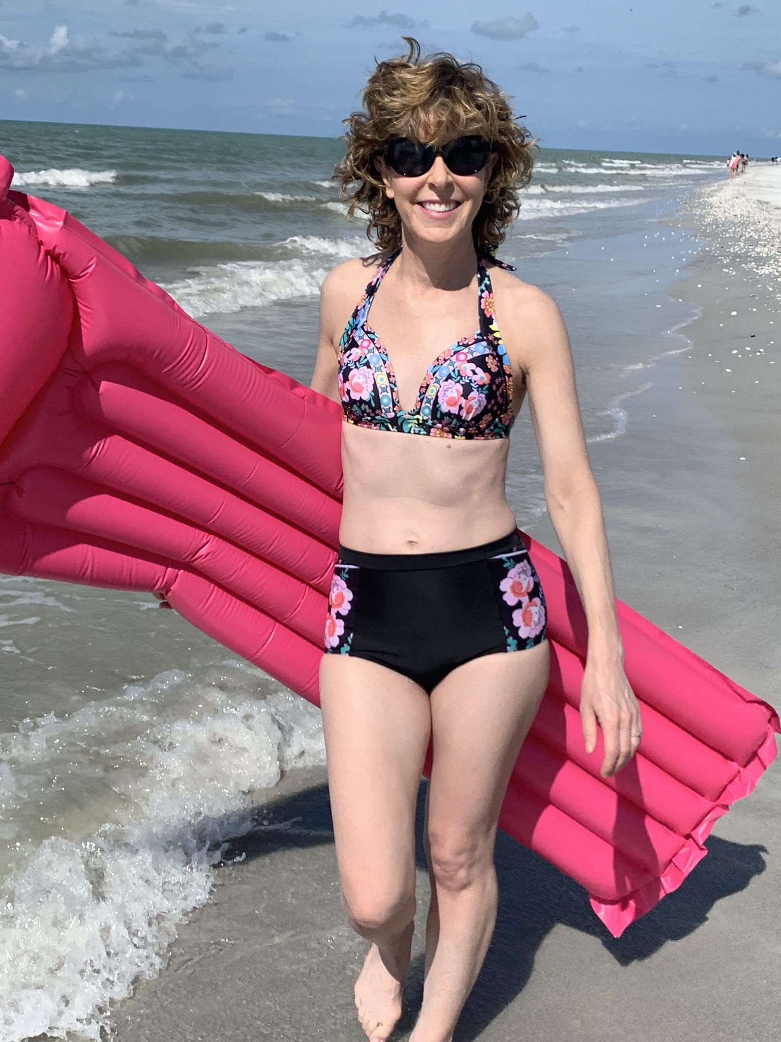 woman in bikini walking on the beach in sanibel island