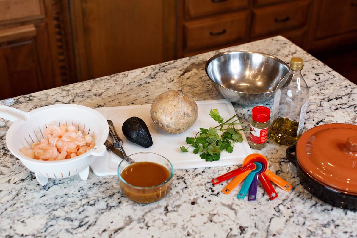 woman making southwestern shrimp recipe in kitchen