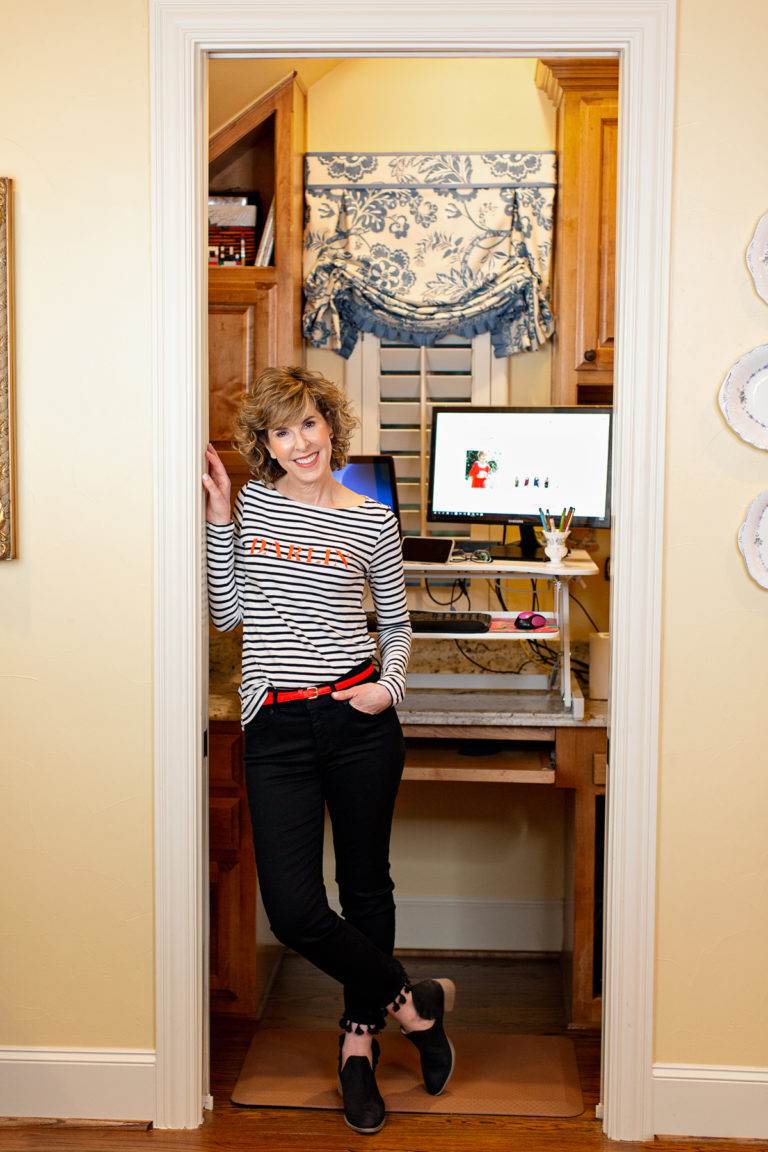 woman standing in doorway of small home office