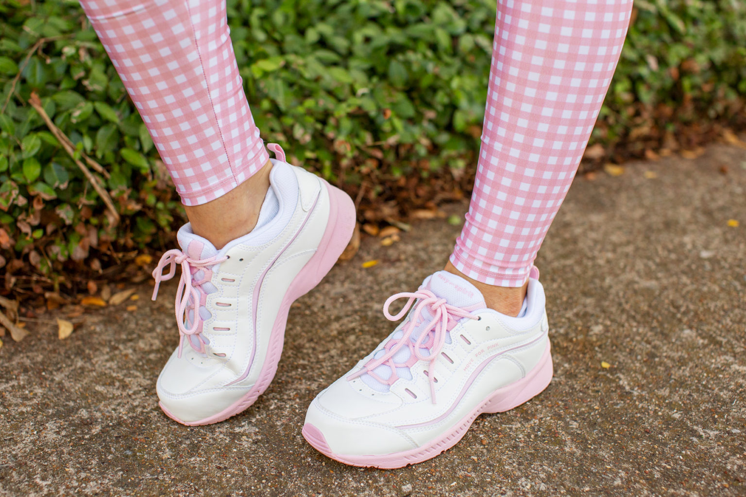 womans feet in pink and white easy spirit tennis shoes