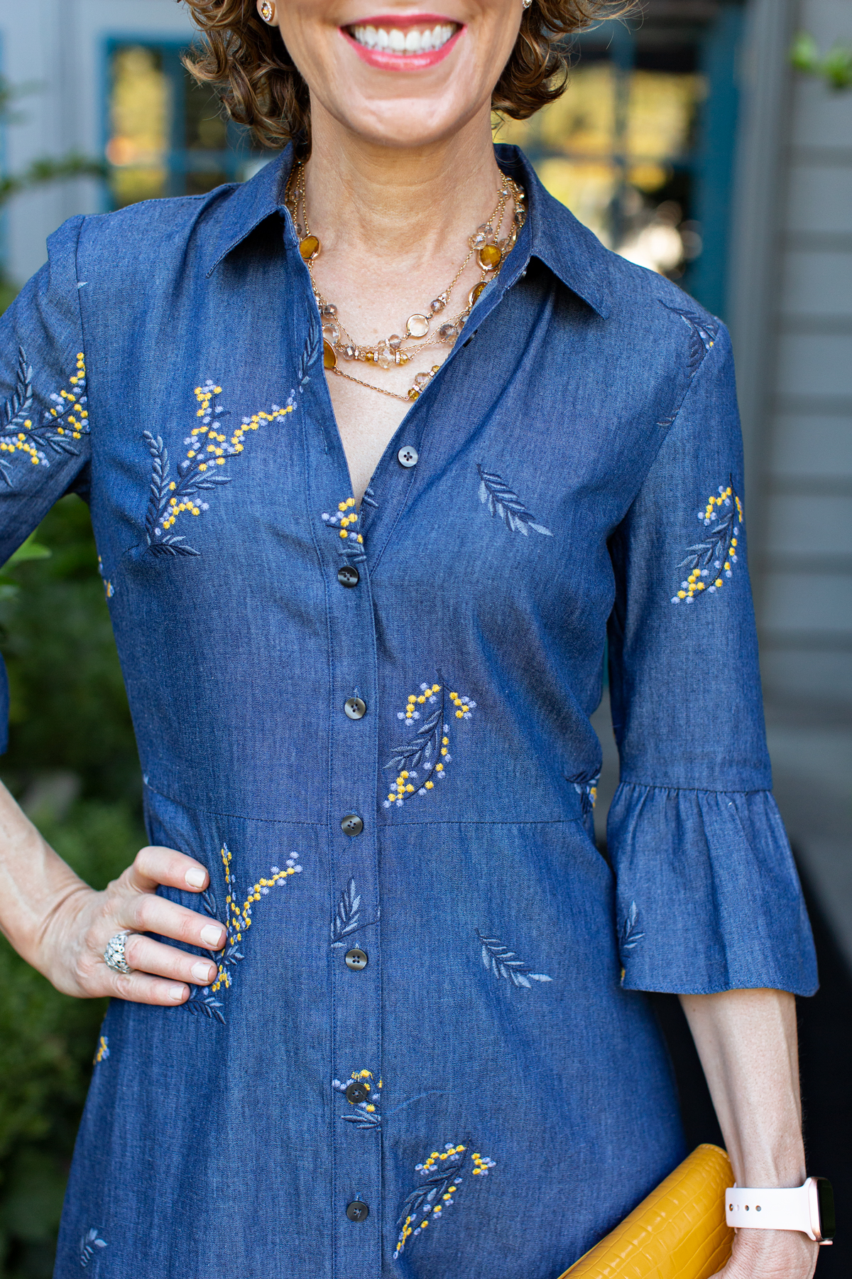 woman in blue dress with embroidered yellow flowers