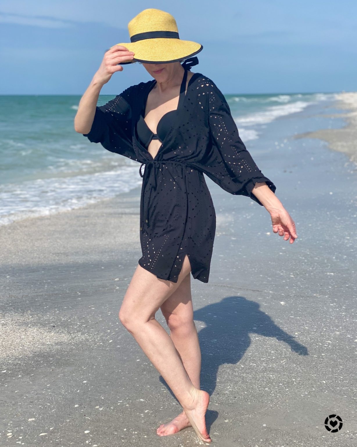 woman in black coverup on beach