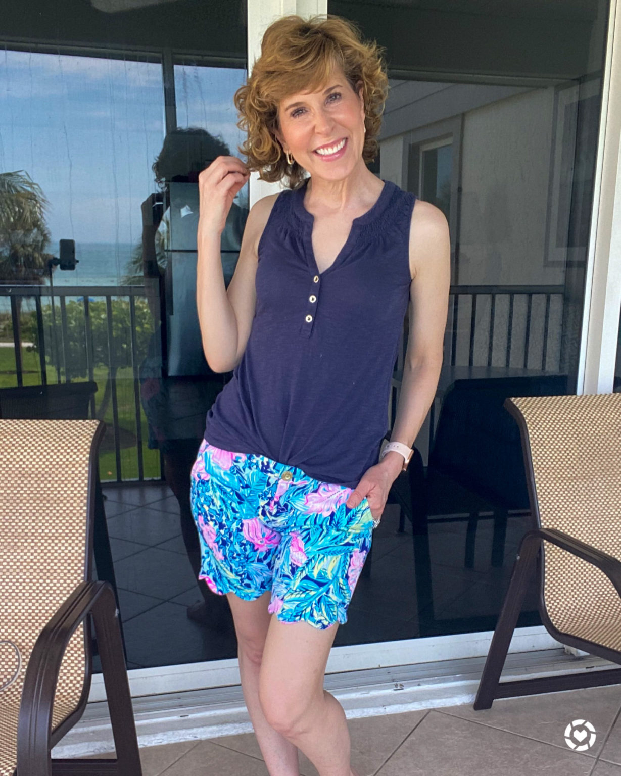 woman wearing lilly pulitzer short and top standing on patio