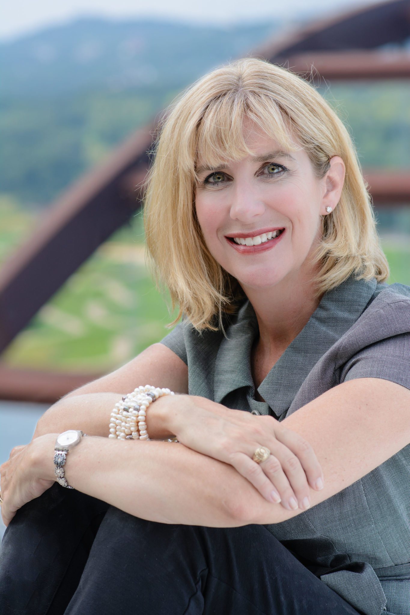 photo of blond woman sitting outdoors