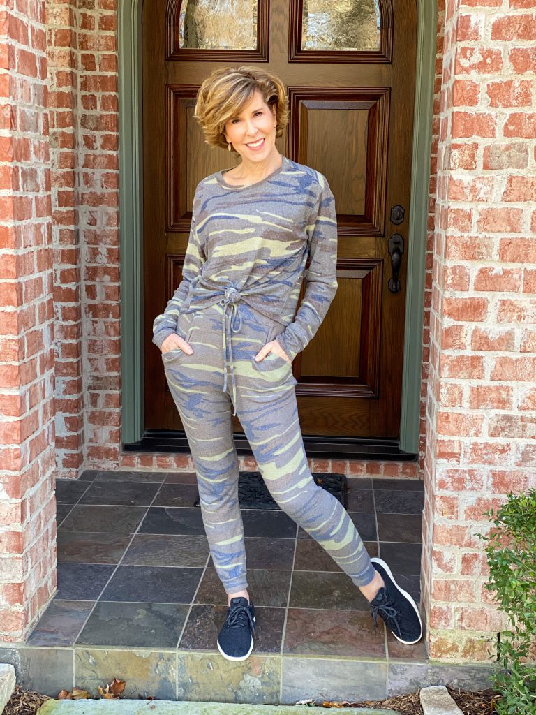 woman wearing kell parker camo jogger set standing on front porch