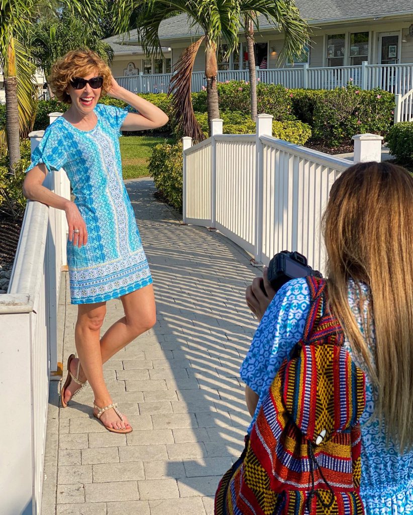 woman over 50 wearing cabana life Coastal Cottage Tie Sleeve Swing Dress standing on a white bridge