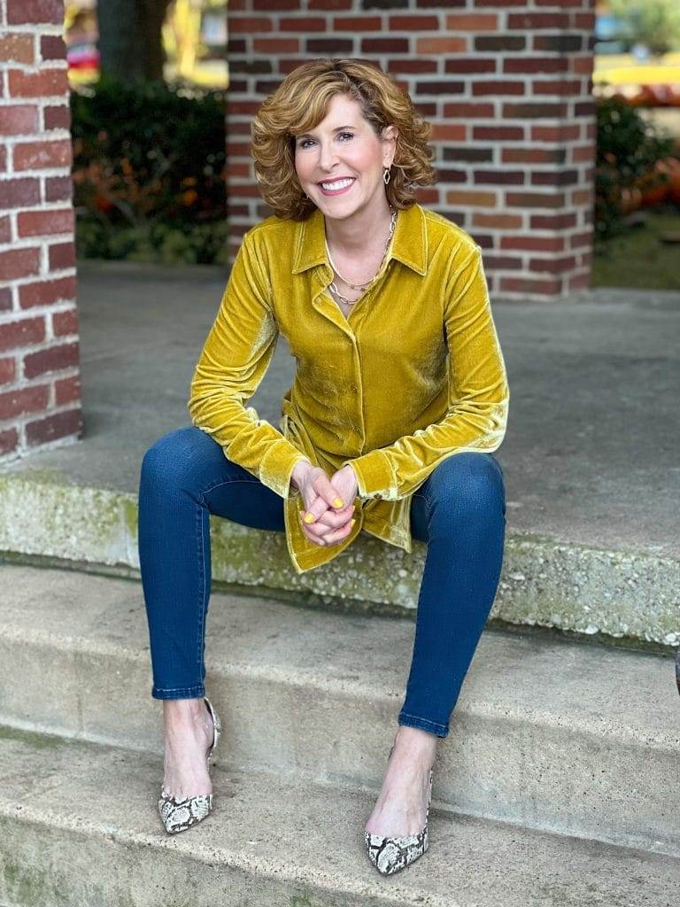 woman wearing soft surrondings icon collection velvet boyfriend shirt and Supremely Soft Relaxed Straight Jeans sitting on a staircase