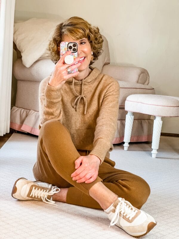 woman dressed in jcrew super soft pink hoodie e joggers and jcrew track sneakers taking a selfie