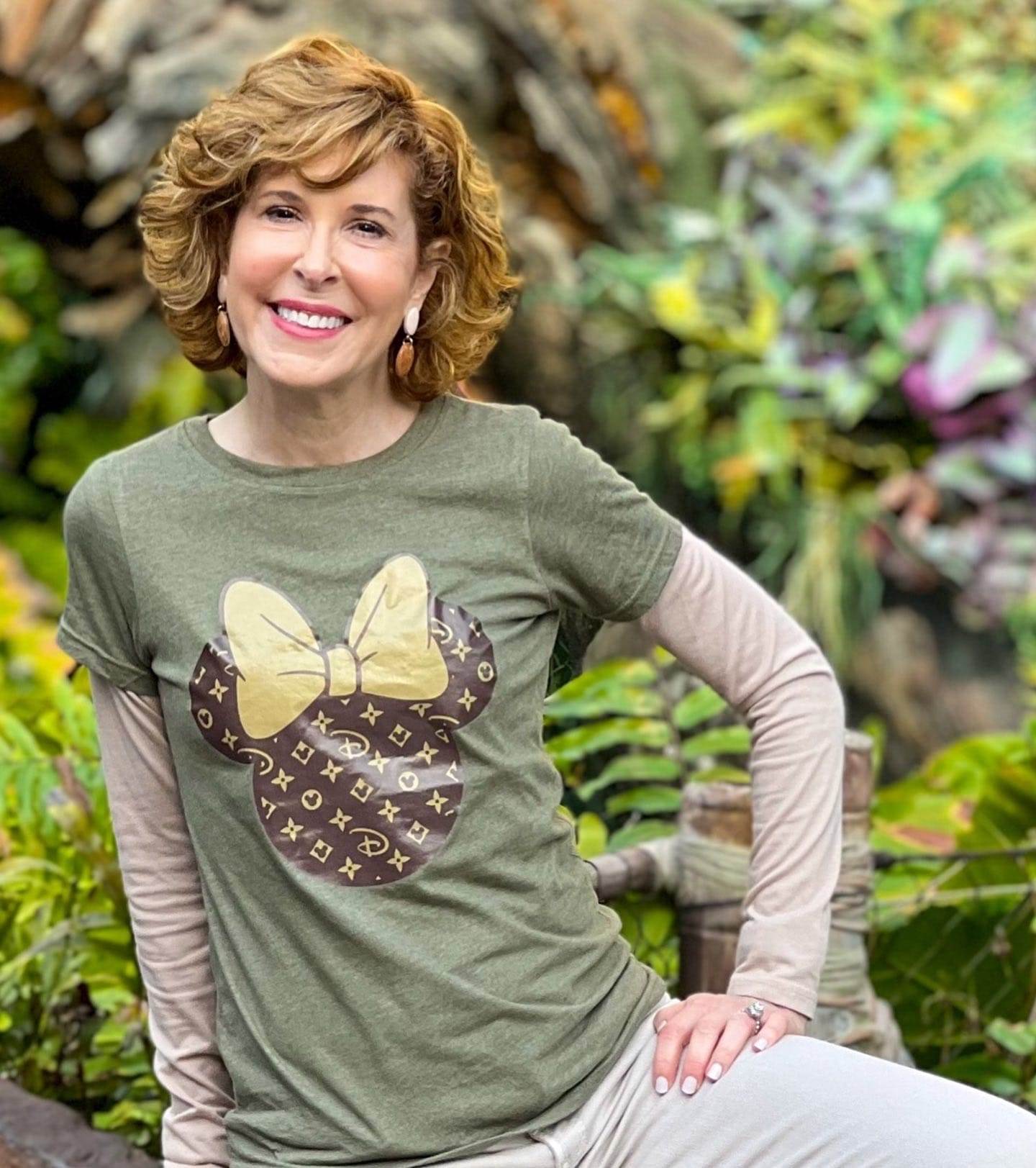 close up of woman over 50 wearing woman in louis vuitton-inspired minnie mouse tee at disney's animal kingdom