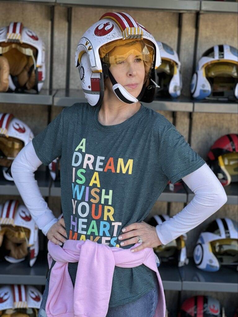 woman wearing star wars helmet in start wars land at disney's hollywood studios