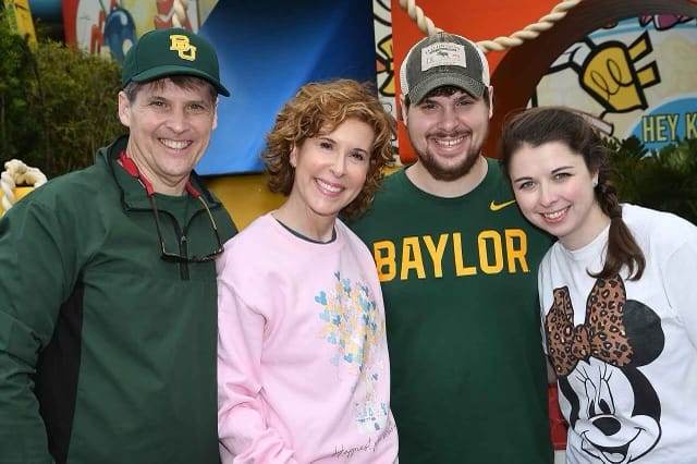 family on multi-generational disney trip standing in front of toy story land in disney's hollywood studios