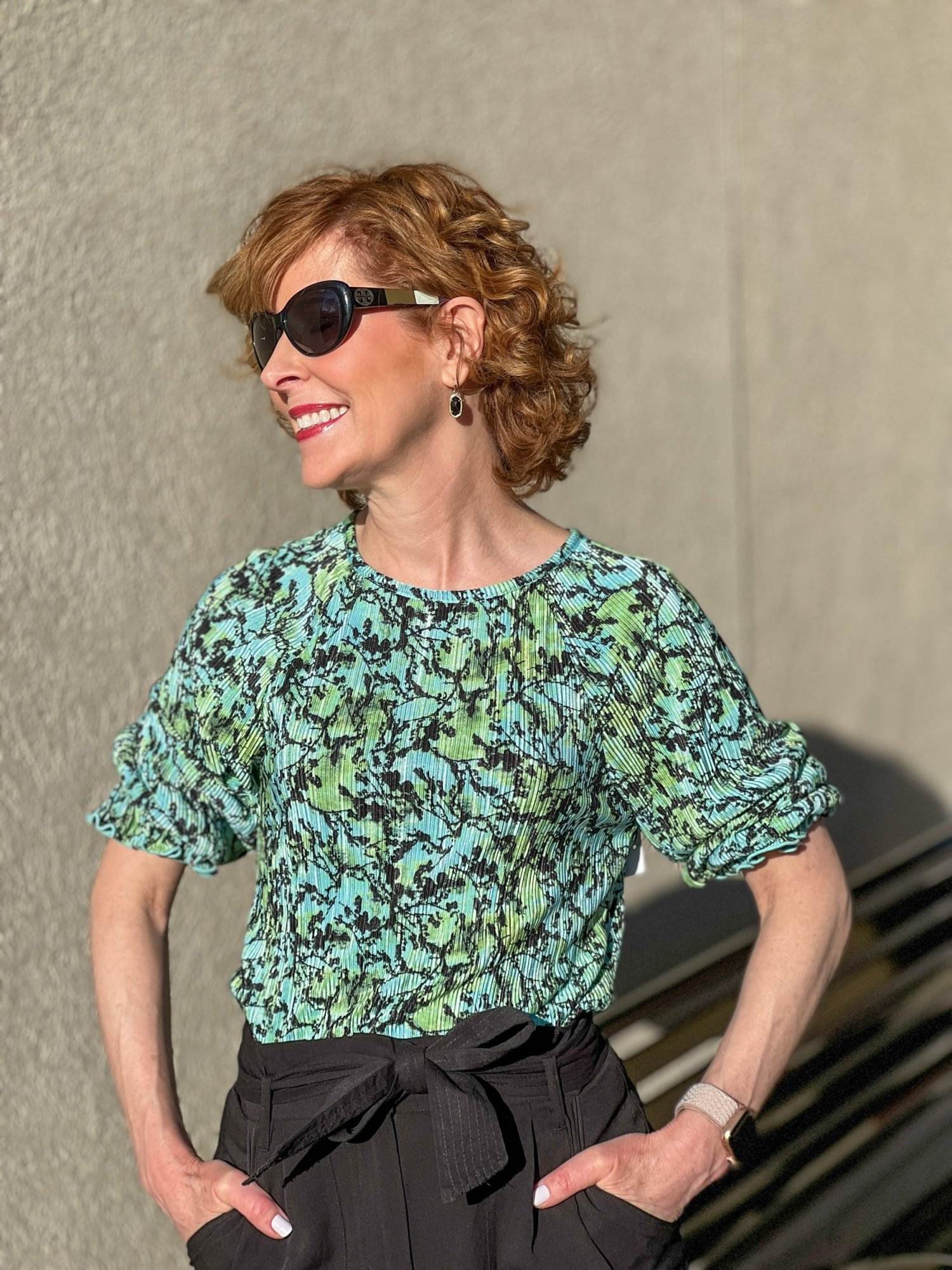 woman wearing sunglasses facing the camera wearing Plissé Top