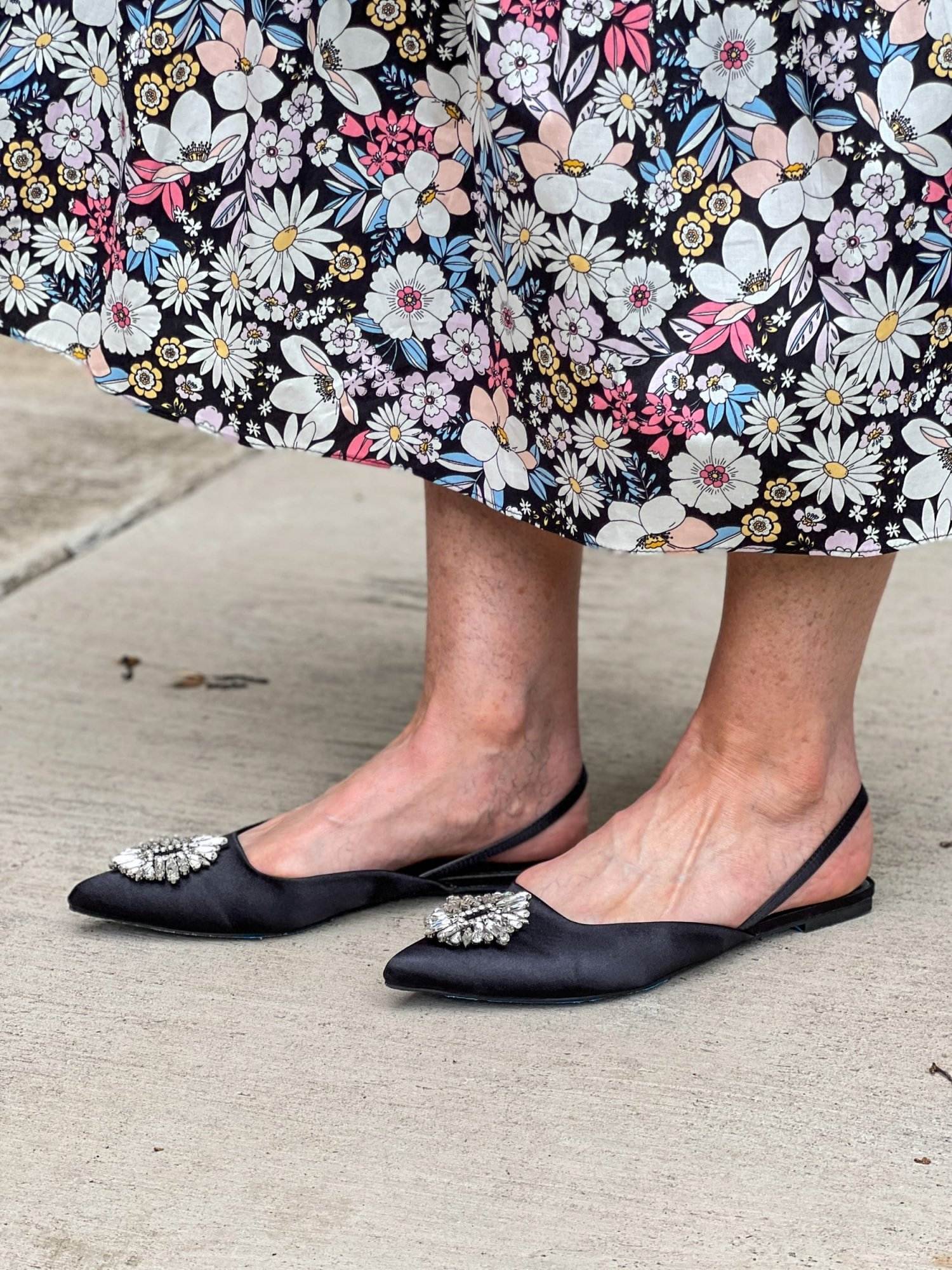 woman's feet from the side wearing Kendall Ornament Pointed Toe Slingback Flat to a summer wedding