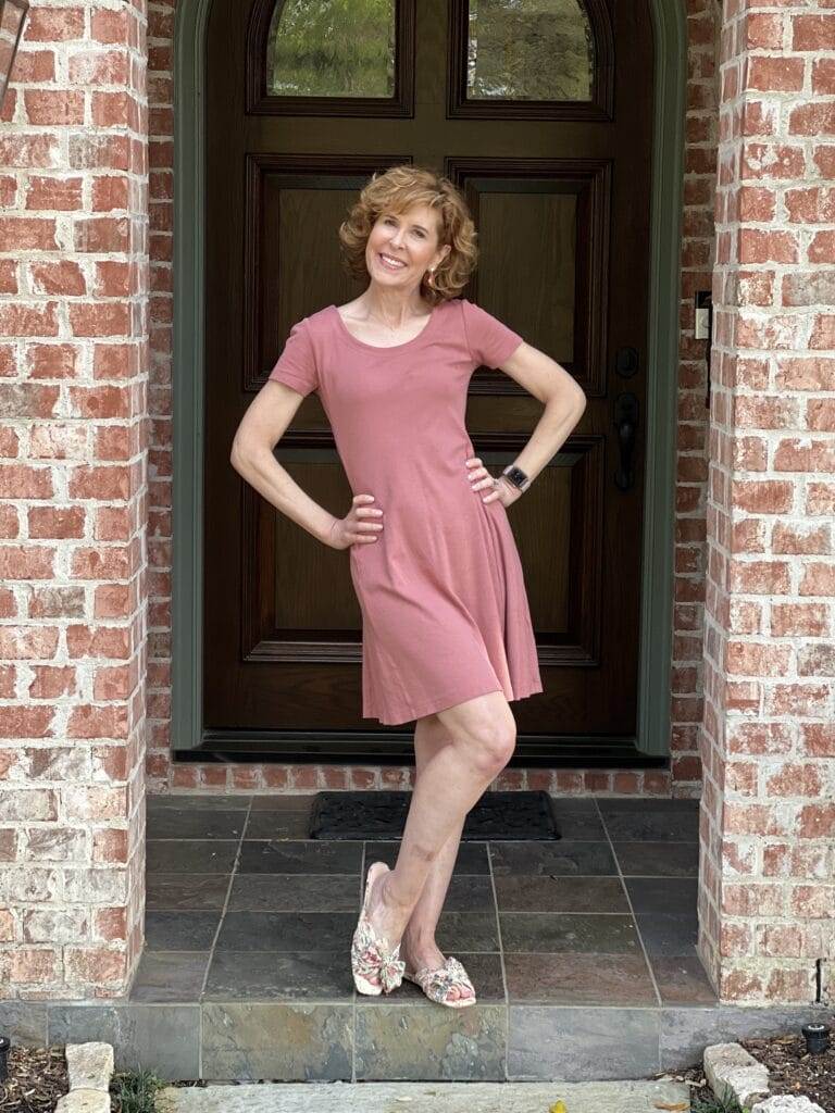 woman  over 50 wearing amazon daily ritual pink dress standing on front porch