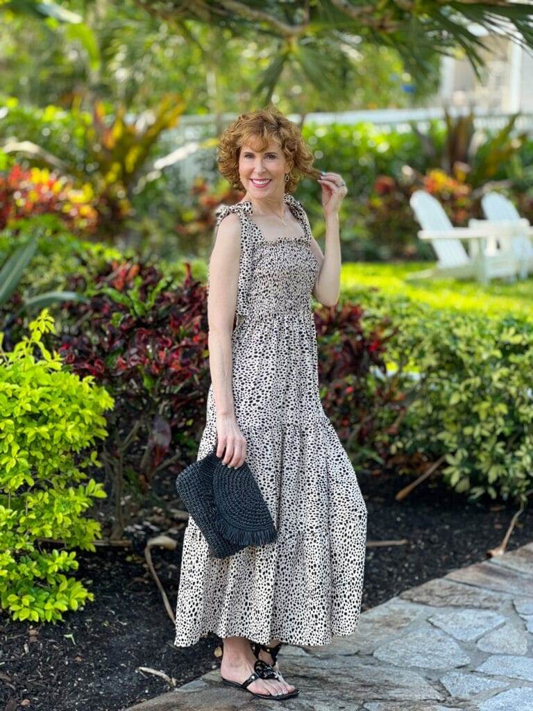 over 50 model posing in a smocked bodice animal print sundress