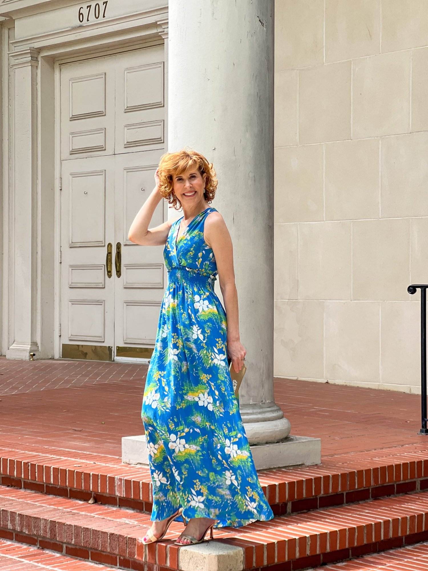 woman standing on the porch of a church wearing Halogen® Wrap Front Halter Dress