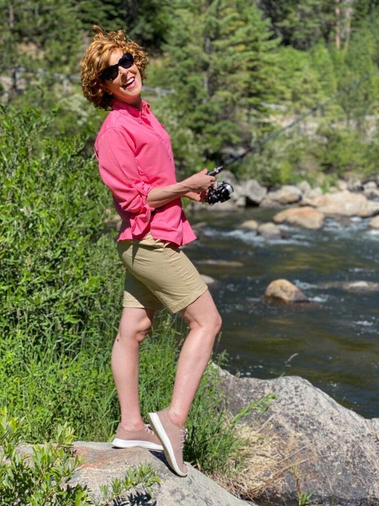 woman fishing wearing sun protrective clothing from columbia