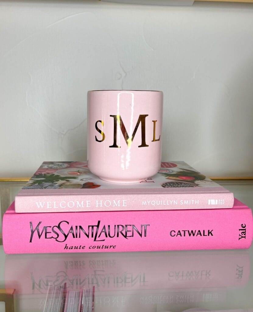 pink coffee table books and pink monogrammed candle