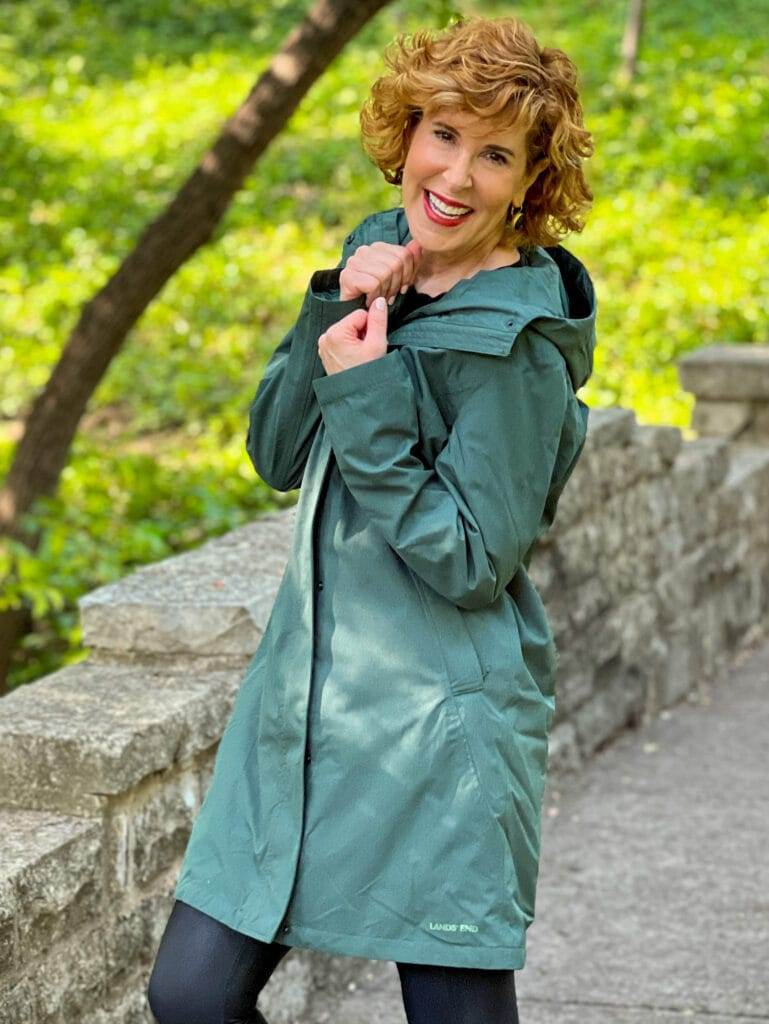 woman wearing green land's end Women's Insulated 3 in 1 Primaloft Parka – outer rain coat part - and black leggings on a bridge in the park