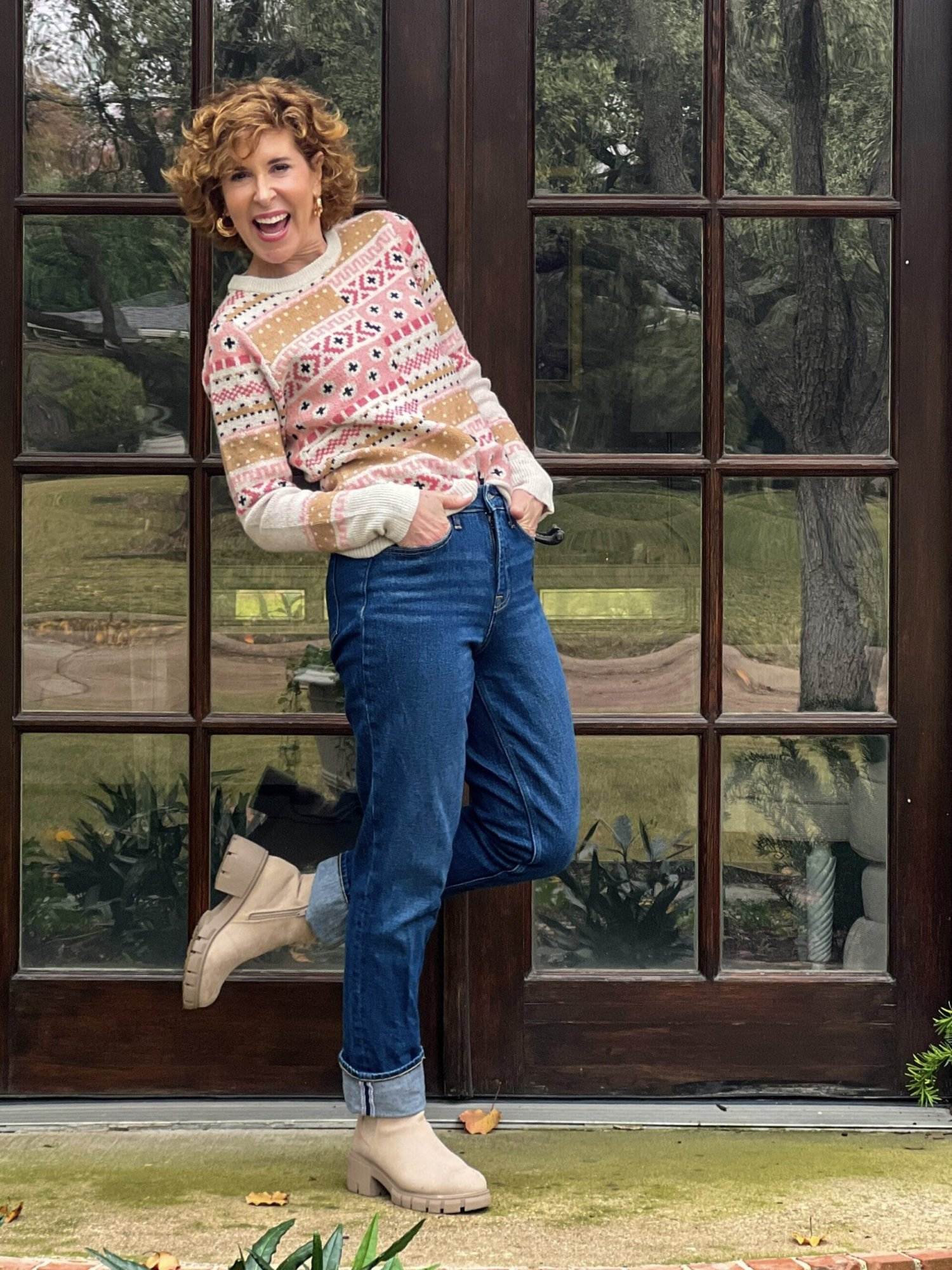 woman over 50 wearing intarsia sweater from walmart standing in front yard showing affordable christmas gifts