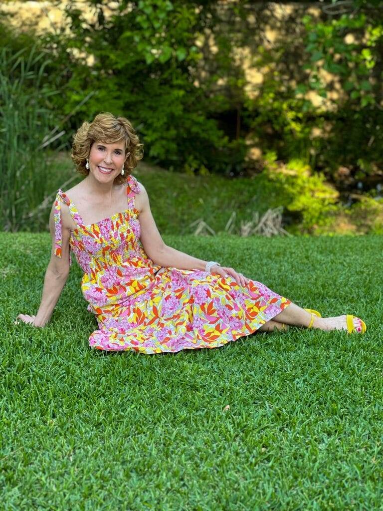 woman wearing colorful avara dress sitting on the grass