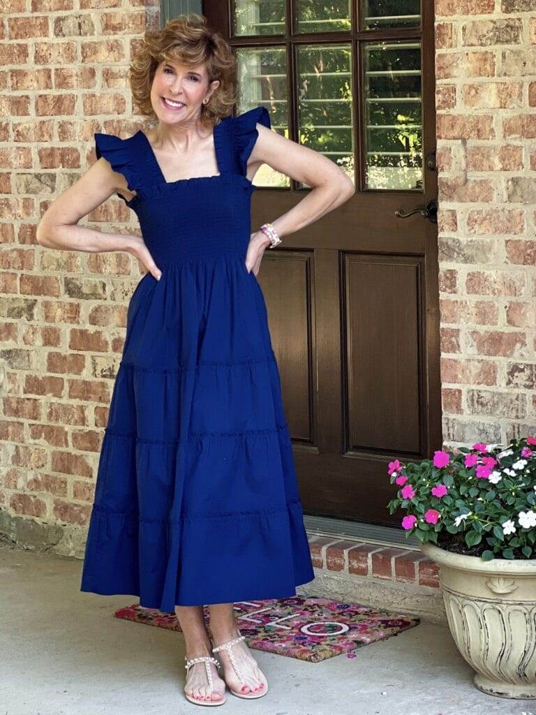 woman wearing hill house home nap dress standing by a back door