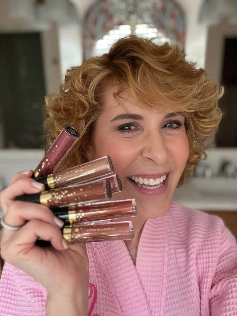 woman holding laura geller beauty chromatic lip tints