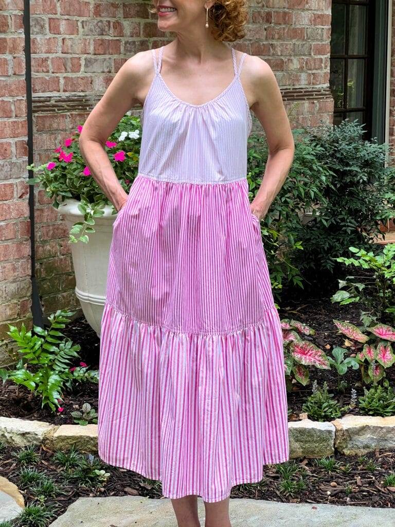 woman's body in a backyard wearing pink and white walmart midi dress