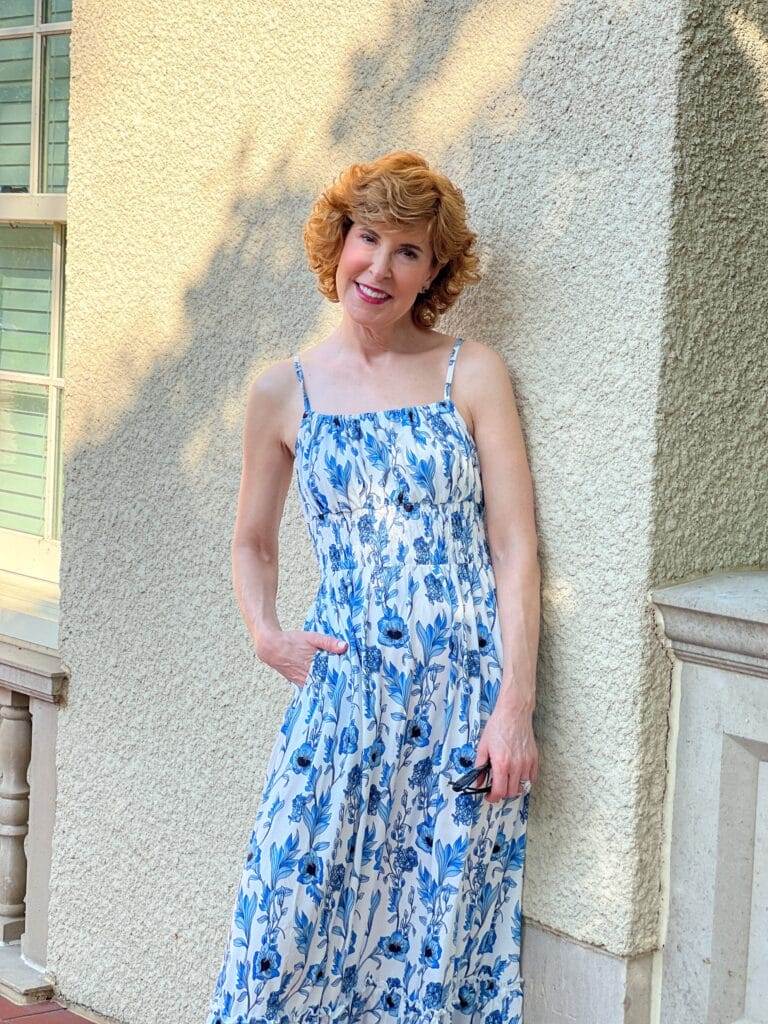 woman standing against a white wall wearing grace karin sundress