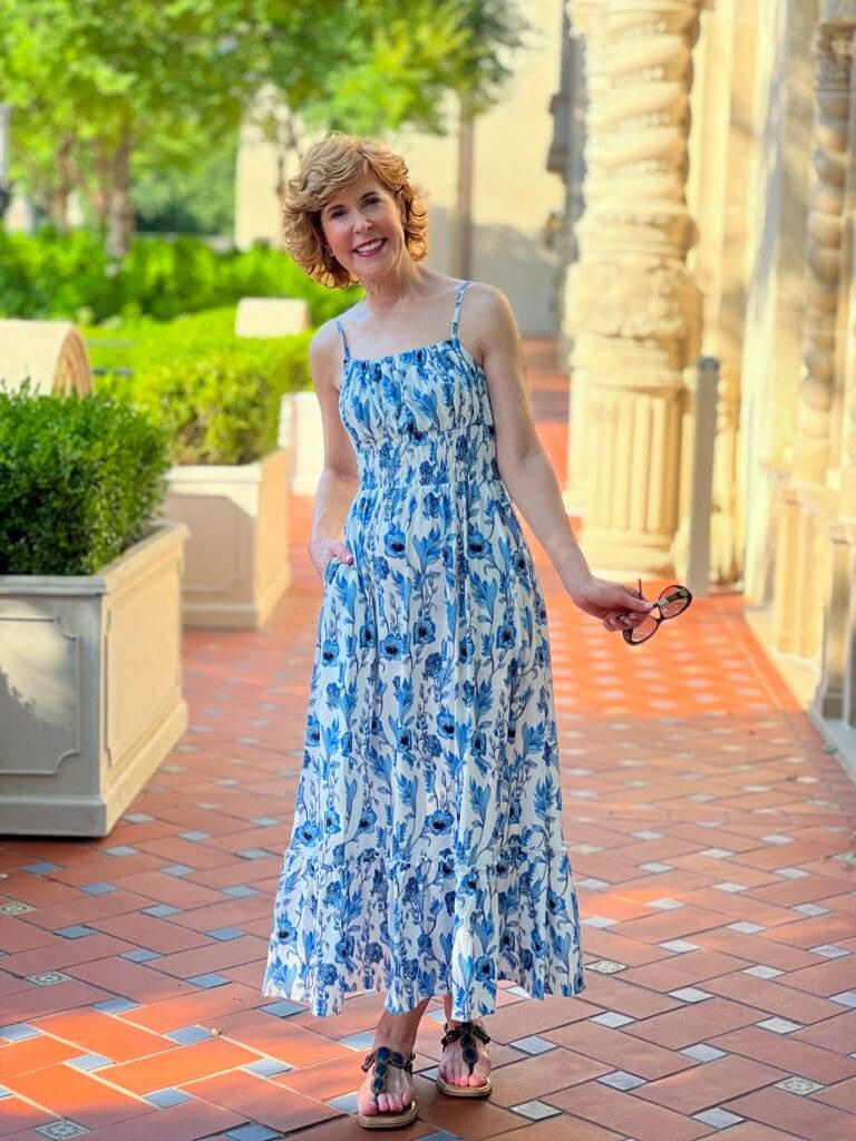 woman standing on red tile floor outdoors wearing grace karin sundress