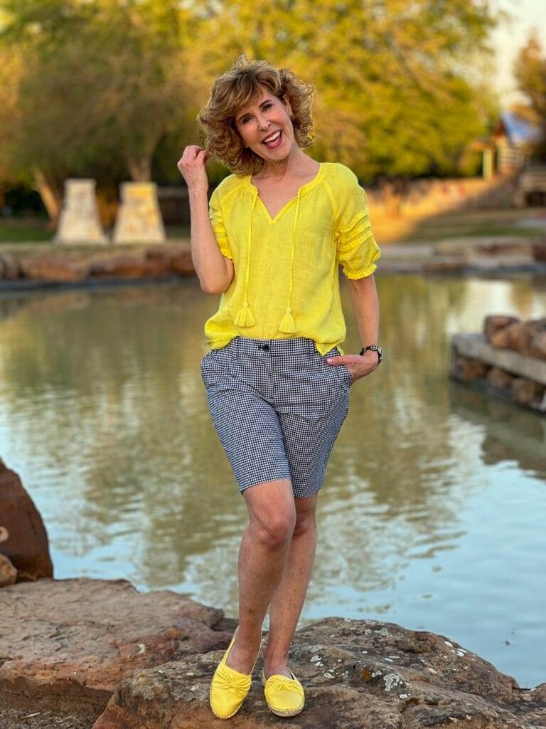 woman standing by a pond wearing Talbots
Pleated Sleeve Linen Top and gingham shorts with yellow leather espadrilles