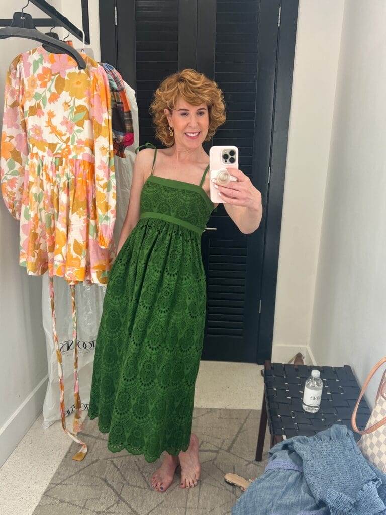 woman taking mirror selfie of green eyelet dress