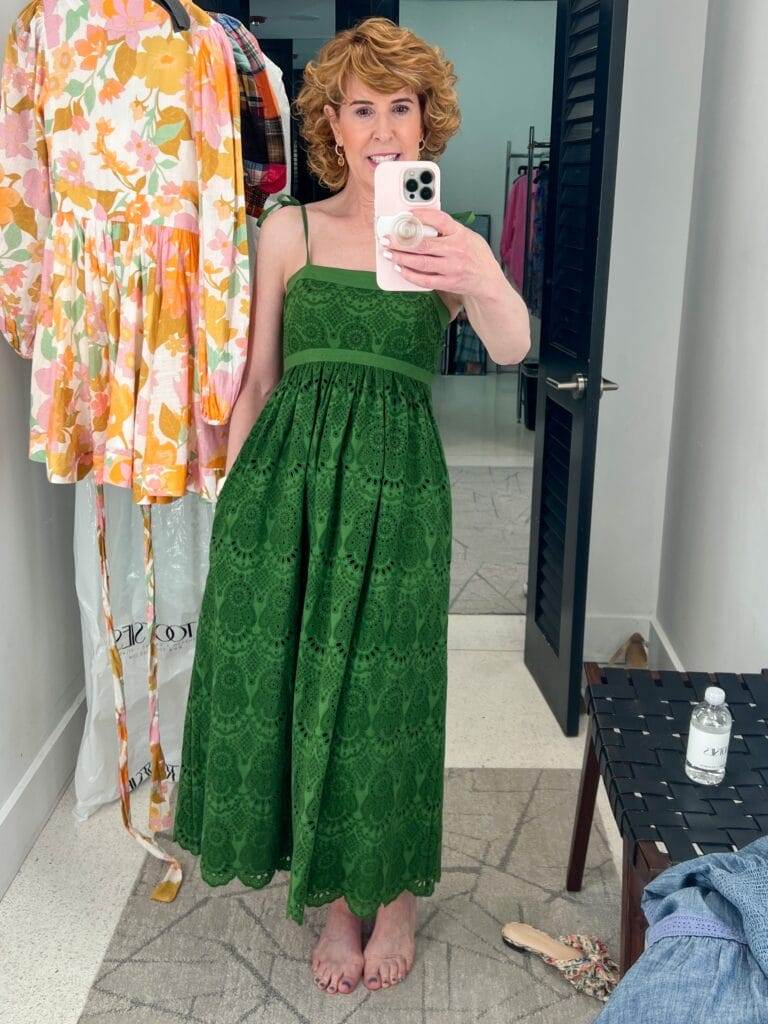 woman taking mirror selfie of green eyelet dress