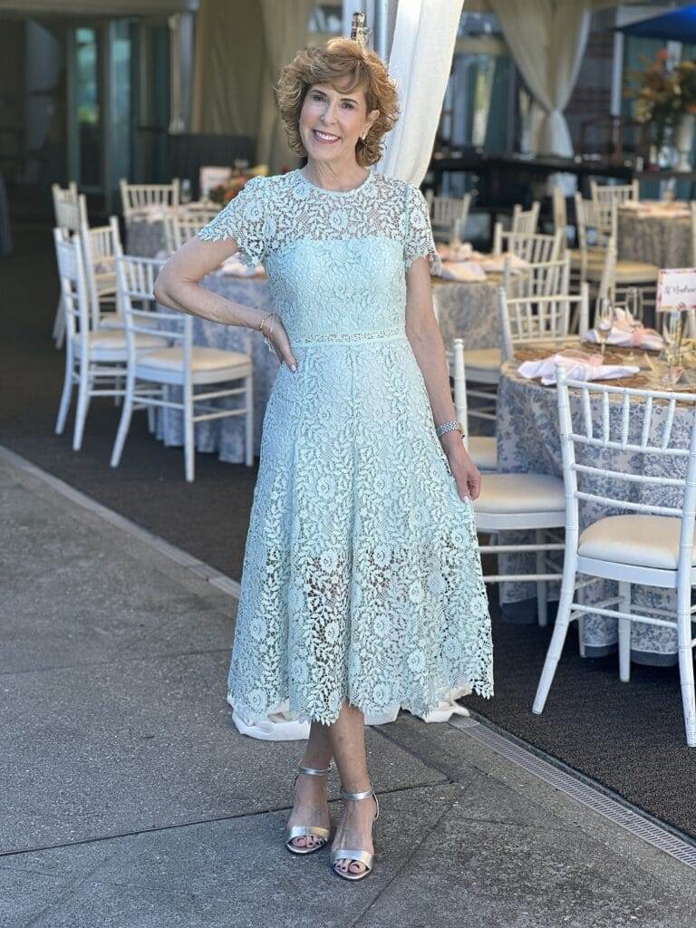 woman standing in front of a room set for a a party