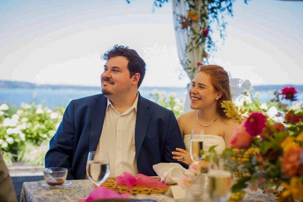 couple listening to toasts at their rehearsal brunch