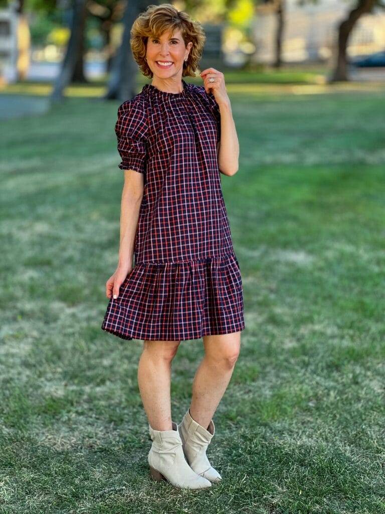 woman over 50 wearing fall transition dress in navy plaid