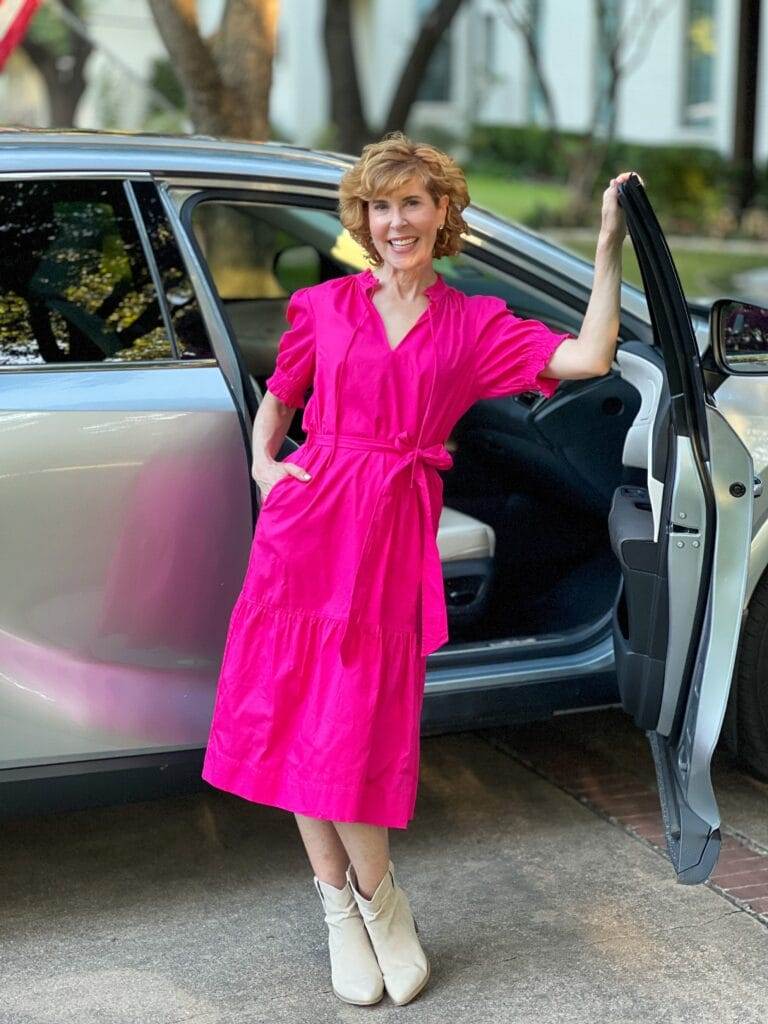 woman standing near her car wearing hot pink midi dress