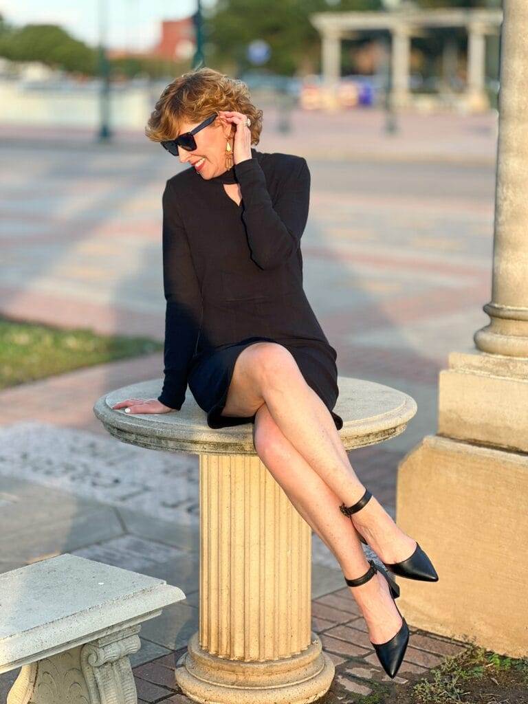 woman sitting on a table in a black dress wearing easy spirit emila  feet change with age 