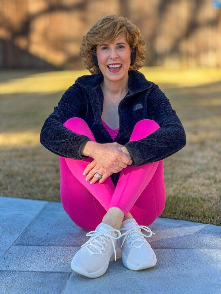 woman sitting cross-legged outside talking about her 2024 fitness goals