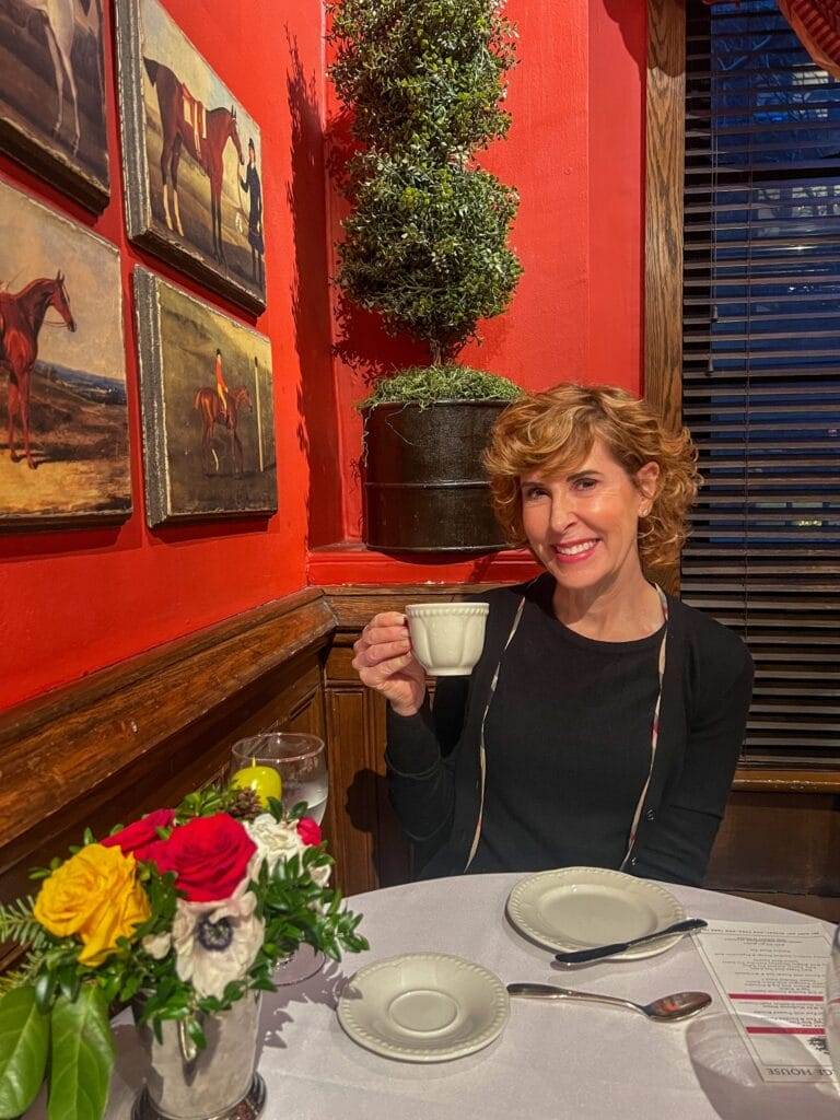 woman holding a tea cup dressed in black