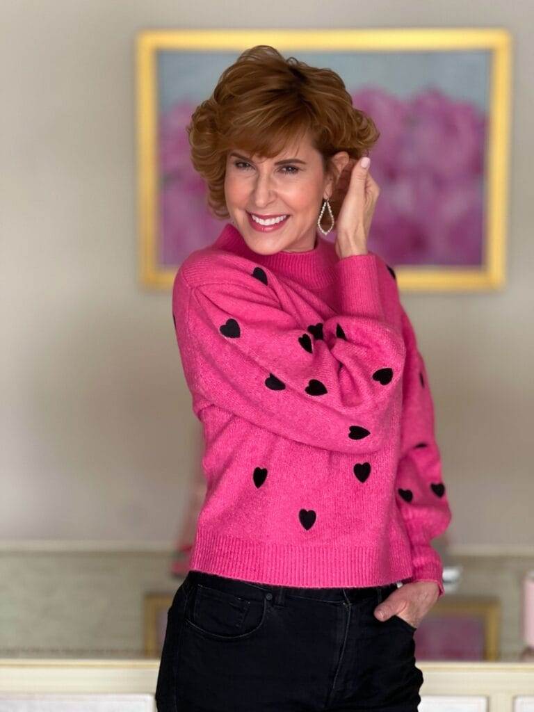 woman in office posing in shop avara's kaity sweater