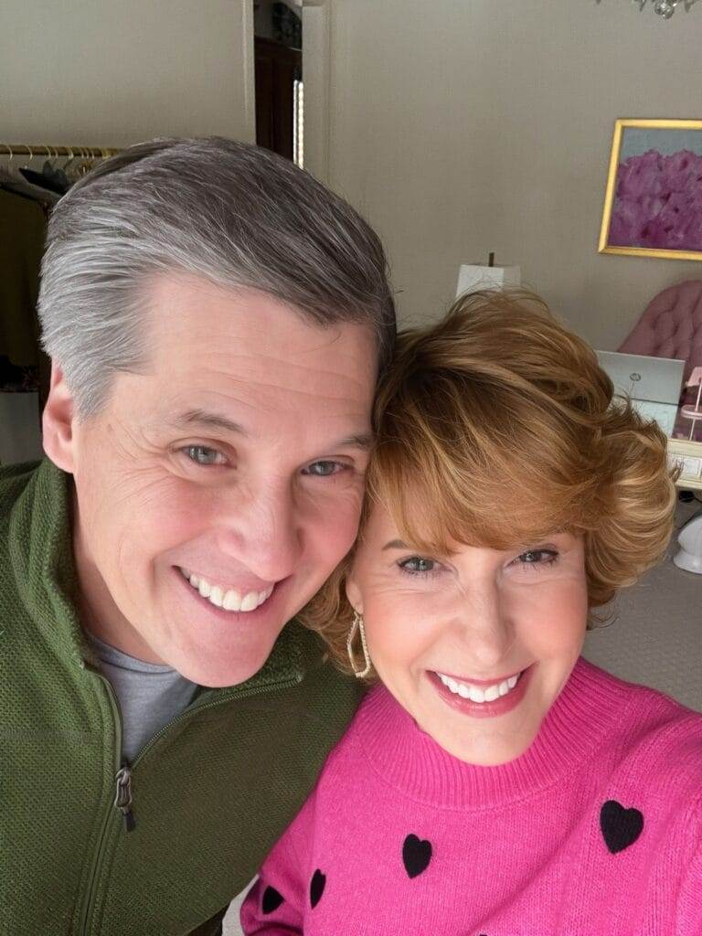 Couple over 50 taking a selfie indoors and working on how to nurture your empty nester marriage.