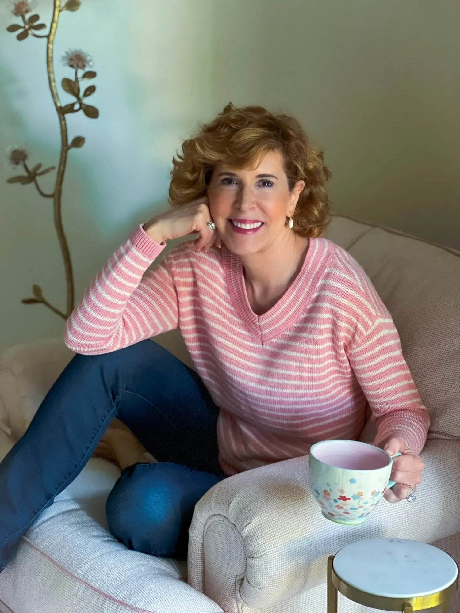 woman sitting in chair with cup of coffee