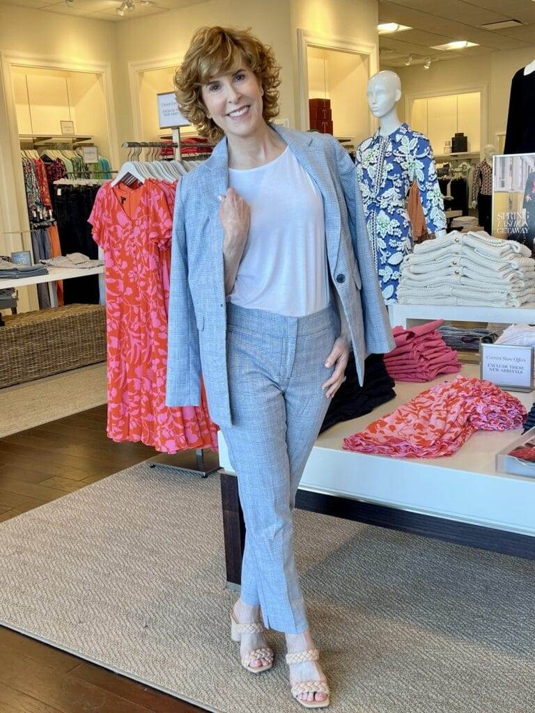 woman posing in talbots store wearing a blue suit