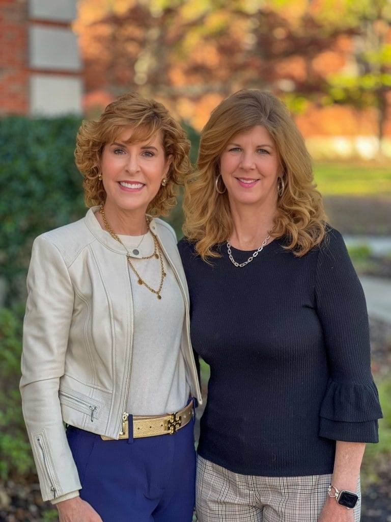 two women posing outside