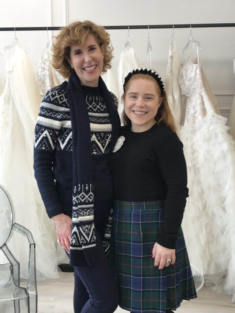 Woman over 50 and bride shopping for wedding dresses