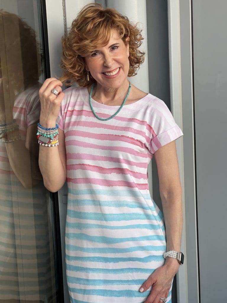 woman standing on balcony of a cruise ship wearing talbots tshirt dress