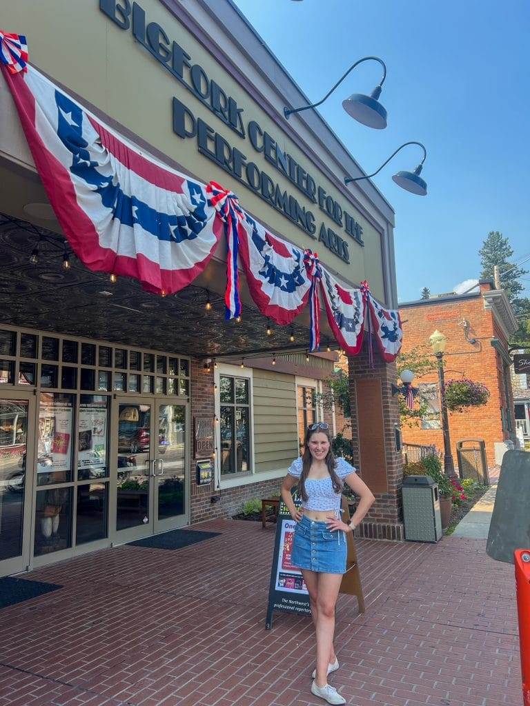 girl in front of bigfork mountain playhouse in bigfork montana